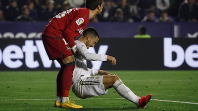 Levante's Aitor Fernandez helps Real Madrid's Eden Hazard. Reuters