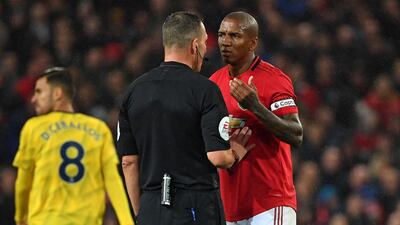 Manchester United's Ashley Young appeals to referee Kevin Friend after an offside goal from Arsenal striker Pierre-Emerick Aubameyang is overturned by VAR. AFP