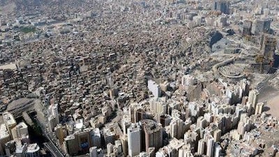 The Omar mountain development projects (right) sit beside a slum area in the holy city of Mecca in Saudi Arabia.GO WITH AFP STORY BY LYNNE NAHHASAn aerial view dated October 27, 2012 shows the Omar mountain development projects (R) next to a slum area in the holy city of Mecca, in Saudi Arabia. Close to Mecca's Grand Mosque and the glitzy 5-star hotels surrounding it lie slums whose mostly immigrant dwellers fear they will be evicted to make way for new high rises and malls. AFP PHOTO / STR *** Local Caption *** 874913-01-08.jpg