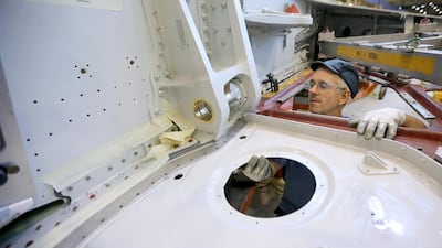 Technicians work on the wing of an Airbus A320 in Broughton. Christopher Furlong / Getty