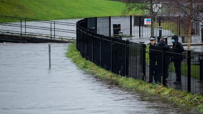Police watch the rising level of the River Roch in Rochdale. EPA