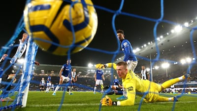 Everton goalkeeper Jordan Pickford watches Newcastle United defender Florian Lejeune's overhead kick hit the back of the net during their Premier League match at Goodison Park on Tuesday, January 21. Lejeune scored twice in injury-time to earn his side a 2-2 draw. Getty
