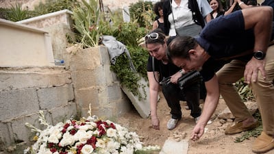 Mourners pay their respects to the Syrian novelist at the Taghaleb martyrs cemetery, in Al-Muhajreen district