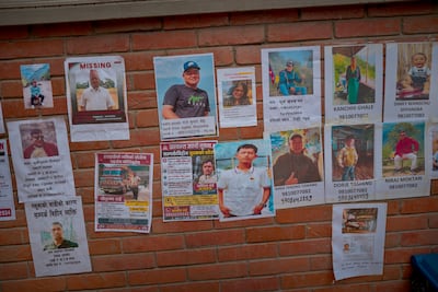 Photos of people reported missing are seen at a teaching hospital in Kathmandu. Getty Images