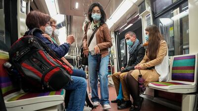 People wear face masks to protect against Covid-19 as they ride a subway in Paris. AP