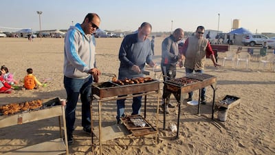 Men barbecue at the camp on January 13, 2017. Yasser Al Zayyat / AFP