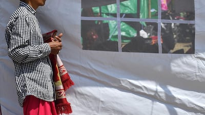 An Indonesian Muslim man attends congregational Friday prayers on a field near temporary shelters in Pemenang, northern Lombok. AFP