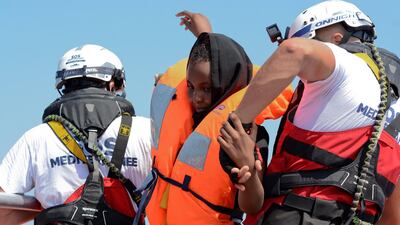 A woman is rescued by SOS Mediterranee in August during a search and rescue (SAR) operation in the Mediterranean Sea. Reuters