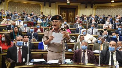 Egyptian General Mamdoh Shahen (2-L) holds up handwritten notes as he speaks during a parliamentary debate session to discuss and vote whether Egypt should send troops to the neighboring civil-war-torn nation of Libya, in Cairo, Egypt. EPA