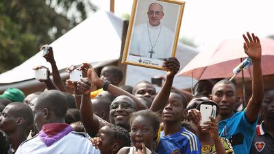 A crowd greets Pope Francis arriving to meet internally displaced people who are sheltered on the grounds of the Saint Sauveur church, during his visit in the capital Bangui, Central African Republic, on November 29, 2015. Siegfried Modola / Reuters