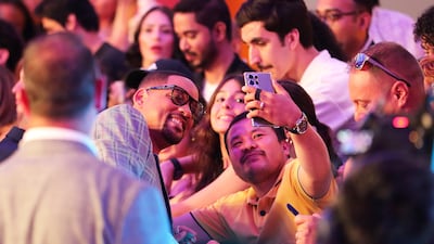 A fan takes a selfie with Will Smith outside the Coca-Cola Arena in Dubai