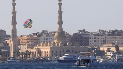 Tourists parasail in front of the Port Grand Mosque in the Egyptian Red Sea resort of Hurghada on August 25, 2020. Reuters