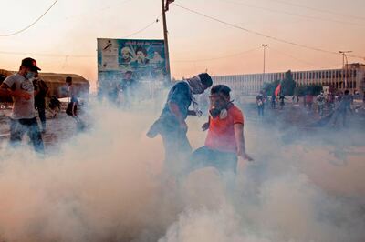 Iraqi protesters wear masks to protect themselves from tear gas as they take part in an anti-government demonstration in Basra. AFP