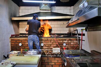 The oven is heated via a gas pipe and then the meat is placed inside and the oven made airtight. Courtesy Charlie Faulkner