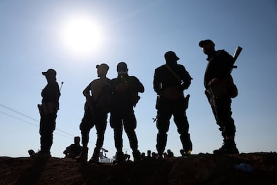 Syrian government forces stand on an earth barrier built during their deployment in the south of the country. AFP