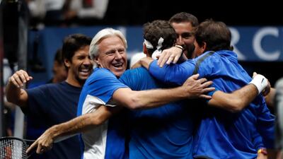 Europe's Roger Federer, centre, celebrates with teammates and team's captain Bjorn Borg, left, after defeating World's Nick Kyrgios during their Laver Cup match in Prague. Petr David Josek / AP Photo