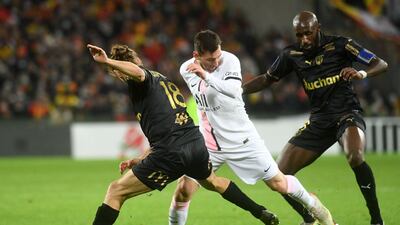 Paris Saint-Germain's Argentinian forward Lionel Messi fights for the ball with Lens' Ivorian midfielder Seko Fofana and Lens' French midfielder Yannick Cahuzac. AFP