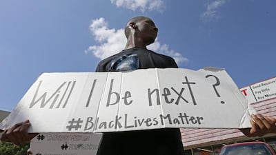 A protester holds a sign at a Black Lives Matter protest in Dallas. Jae S. Lee / The Dallas Morning News via AP