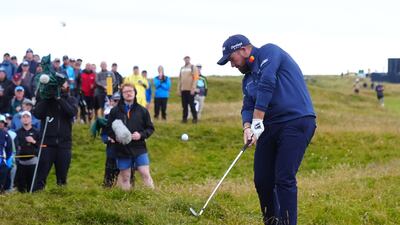 Shane Lowry plays from the rough on the 13th fairway. PA