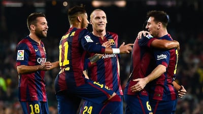 Lionel Messi celebrates with teammates after scoring the team's first goal against Sevilla on Saturday night in La Liga, with the tally bringing him level with Telmo Zarra's Liga goalscoring record, which he would later surpass. David Ramos / Getty Images