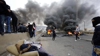 Lebanese anti-government protesters burn tyres as they block the road leading to the southern entrance of the northern port city of Tripoli. AFP