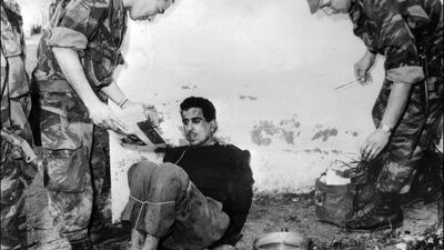 French paratroopers question Algerian Omar Merouane in Saint Eugene in 1957. Relations between France and Algeria continue to be strained because of the colonial past. AFP