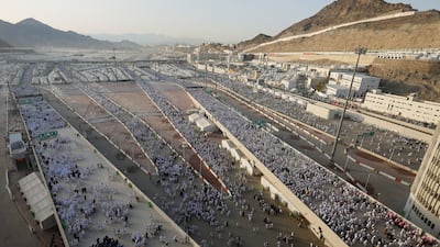 Pilgrims walk before casting their stones. Reuters