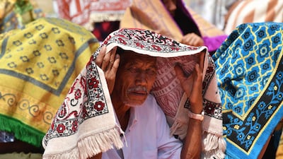 An Indonesian man arrives for Friday prayers on a field near temporary shelters in Pemenang, northern Lombok. AFP