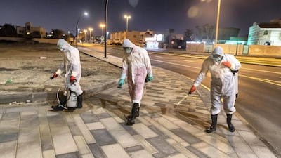 SHARJAH, UNITED ARAB EMIRATES. 26 MARCH 2020. Sharjah Municipal staff spray and disinfect the sidewalk along the Al Muntazah Str area of Sharjah near the Ajman border. . (Photo: Antonie Robertson/The National) Journalist: None. Section: National.