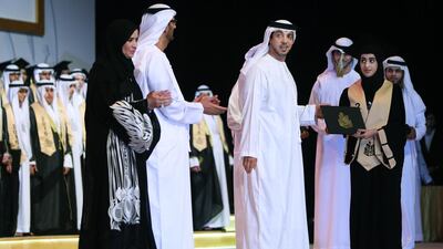 Sheikh Mansour bin Zayed, Deputy Prime Minister and Minister of Presidential Affairs, hands out awards to students. Delores Johnson / The National