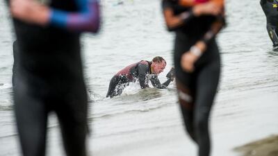 A triathlete struggles to stand after the swim portion of the Escape from Alcatraz Triathlon in San Francisco, California on Sunday. Noah Berger / Reuters / June 1, 2014