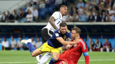 Sweden's Marcus Berg collides with Germany goalkeeper Manuel Neuer during a 2-1 defeat to the world champions. Francois Lenoir / Reuters