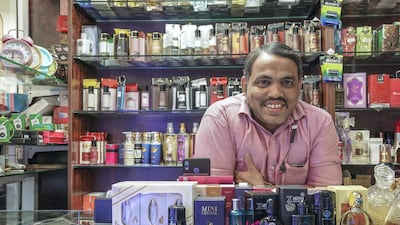 Anwar Mithal displays cosmetic products on sale at his shop.