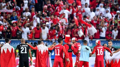 Bahrain players celebrate in front of supporters. EPA