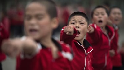 The vast Tagou martial arts school has 35,000 fee-paying boarders, who live in spartan conditions and are put through a rigorous training regime. Nicolas Asfouri / Agence France-Presse