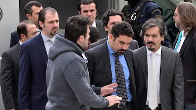 Eight Turkish army officers are escorted by Greek police as they arrive at the supreme court on January 26, 2017. Louisa Gouliamaki /AFP