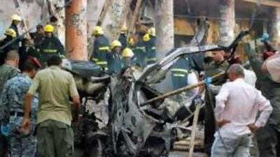 Security personnel and rescue workers gather at the site of last week's car bombing in Kut that killed 15 people.