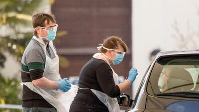A medical worker takes a swap at a coronavirus drive-through testing centre in the car park of the closed Chessington World of Adventures Resort theme park in Chessington, Greater London. Bloomberg