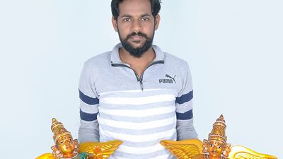 Santoshkumar Chitragar with two of his handmade figurines