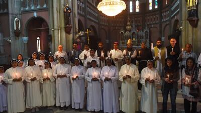Pakistani Christians and Muslims hold candles at a tribute to bomb blast victims at the Sacred Heart Cathedral Church in Lahore. AFP