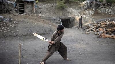 A miner plays cricket in the evening at a coal field in Choa Saidan Shah, Punjab. Sara Farid / Reuters