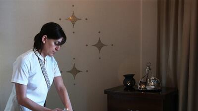 The therapist melts a candle made of Moroccan Argan oil and Yemeni frankincense to massage into the skin. Satish Kumar / The National