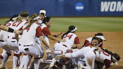 The Oklahoma softball team celebrates defeating Florida to clinch the NCAA Women’s College World Series in Oklahoma City. Sue Ogrocki / AP Photo