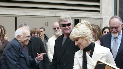 Celine Dion, wearing a chic white skirt suit, is honoured with a star on the Hollywood Walk of Fame on January 6, 2004, in Los Angeles. EPA