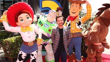 Voice actor John Morris with Toy Story characters. Getty Images