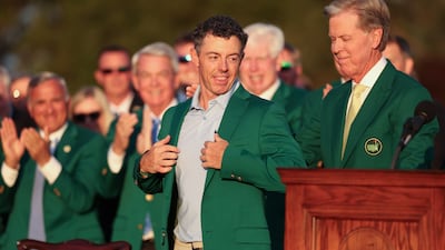 Fred Ripley, chairman of Augusta National Golf Club, right, awards Rory McIlroy the coveted Green Jacket. EPA