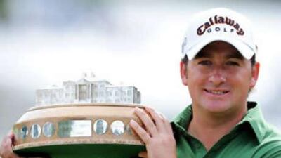 The Northern Ireland golfer Graeme McDowell lifts the Scottish Open trophy at Loch Lomond.