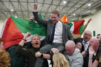 Supporters of Sinn Fein's Donnchadh O Laoghaire display a Palestinian flag in Cork as they celebrate his win in Ireland's general election. PA