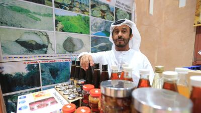 A fellow beekeeper applauds Ali Al Dhahani’s efforts to save the honey bee population. Ravindranath K / The National