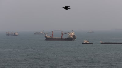 BANDAR ABBAS, IRAN - AUGUST 10: A bird flies past as ships are seen anchored in the Strait of Hormuz on August 10, 2026 off the coast of Bandar Abbas, Iran. In a recent statement, Iran's Supreme National Security Council said the vital waterway would not reopen until the United States corrects its behavior, demanding that the U.S. end its war on Iran and compensate the country for war damage, among other conditions. Iran has largely halted vessel traffic through the strait with the threat of strikes; meanwhile, the U.S. has imposed a blockade on Iranian ports. (Photo by Ali Saeedi / Getty Images)